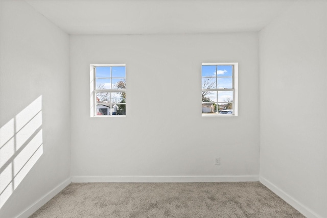 carpeted empty room with a healthy amount of sunlight