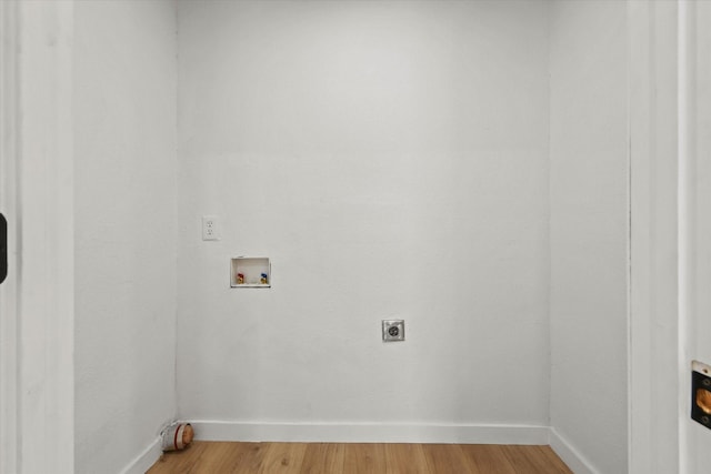 laundry area with electric dryer hookup, washer hookup, and hardwood / wood-style flooring