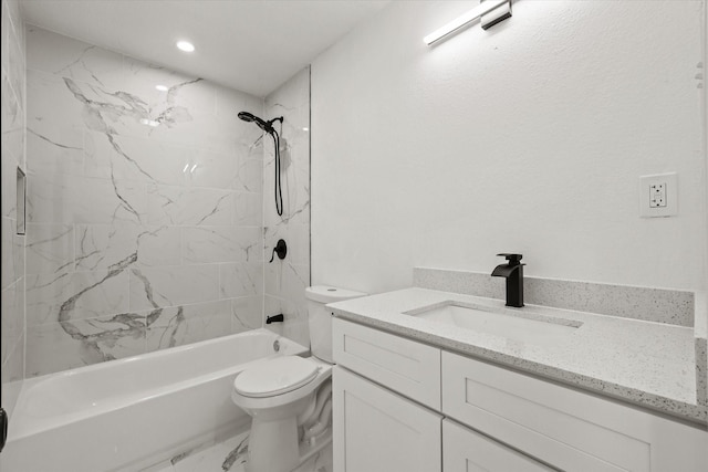 full bathroom with vanity, tiled shower / bath combo, and toilet