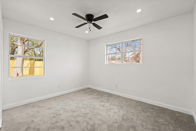 unfurnished room featuring ceiling fan and carpet