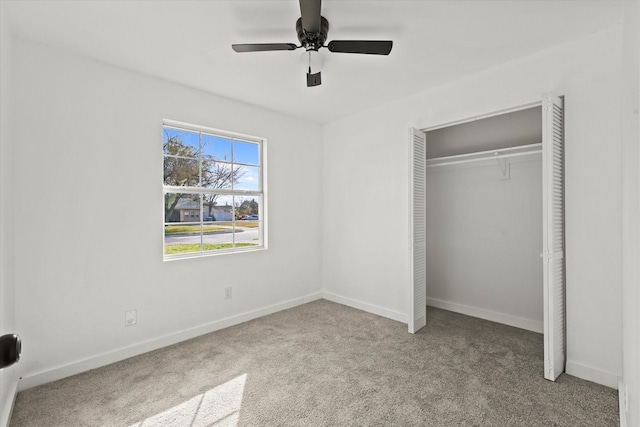 unfurnished bedroom featuring ceiling fan, light colored carpet, and a closet