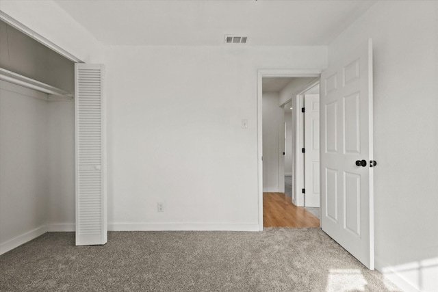 unfurnished bedroom with a closet and carpet