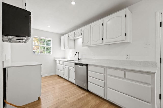 kitchen with dishwasher, sink, white cabinets, and light wood-type flooring