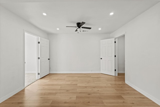 spare room featuring ceiling fan and light hardwood / wood-style floors