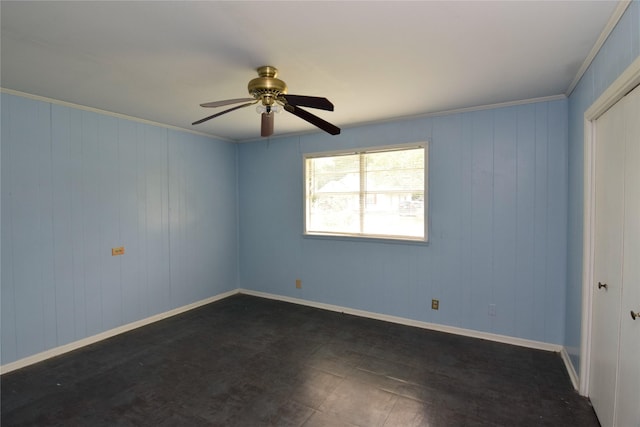 spare room featuring ceiling fan and ornamental molding