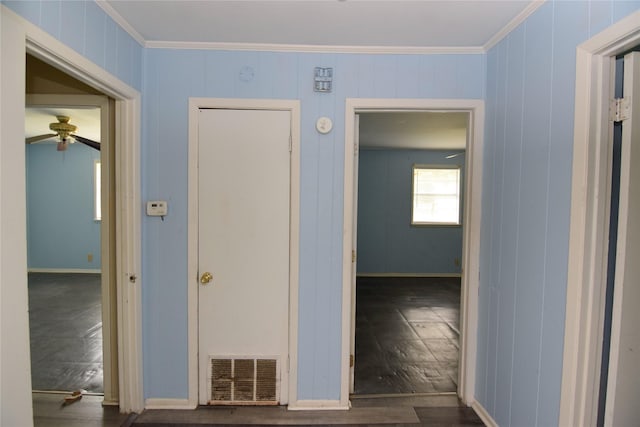 hallway with ornamental molding and dark hardwood / wood-style flooring