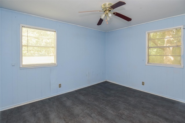 spare room featuring ceiling fan, dark hardwood / wood-style floors, and a healthy amount of sunlight