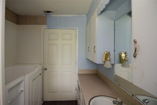 bathroom featuring vanity and a tub