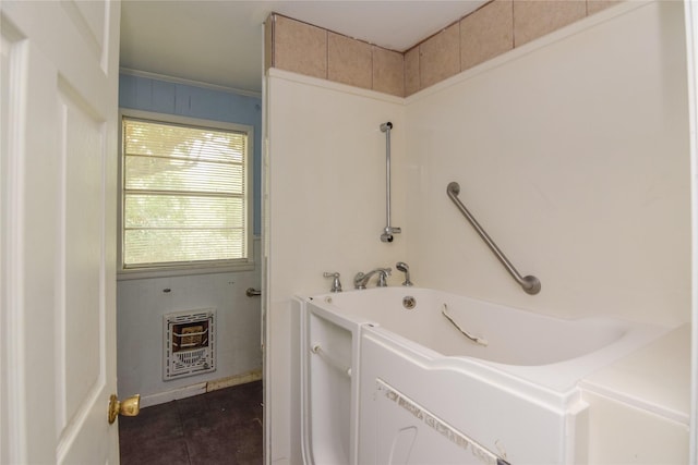 bathroom featuring heating unit, tile patterned floors, and a tub to relax in