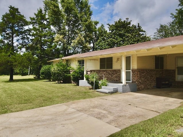 ranch-style home with a carport and a front yard