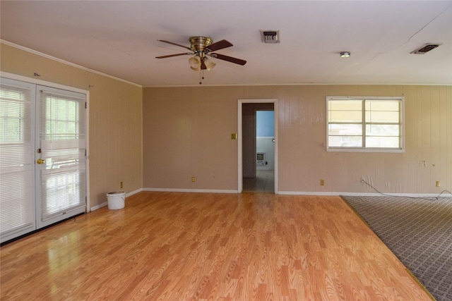 unfurnished room with ceiling fan, ornamental molding, and light wood-type flooring