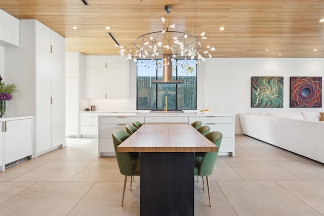 tiled dining area with sink, wood ceiling, and a chandelier