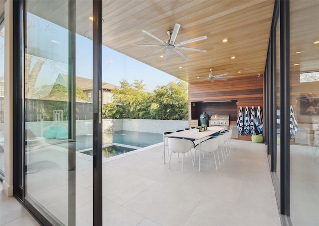 exterior space with ceiling fan, area for grilling, and a patio area