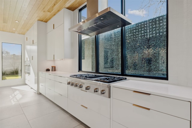 kitchen featuring stainless steel gas stovetop, white cabinetry, island exhaust hood, light tile patterned floors, and wooden ceiling