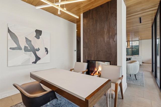 dining room featuring light tile patterned floors, wooden ceiling, and a fireplace