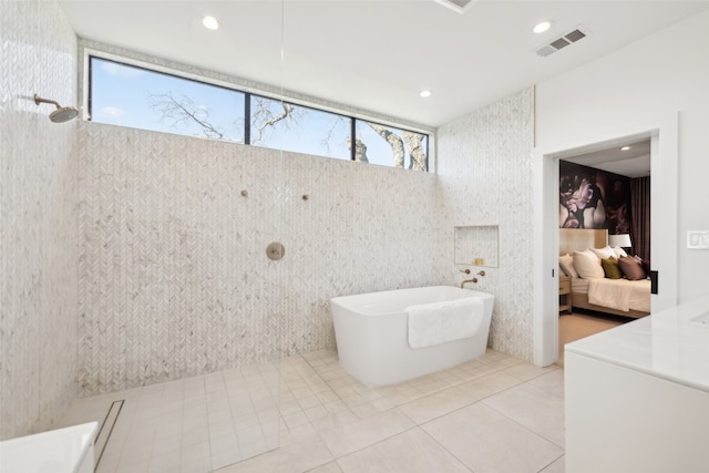 bathroom with independent shower and bath and tile patterned floors