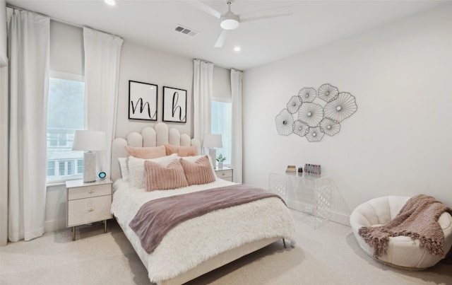 bedroom featuring light carpet and ceiling fan