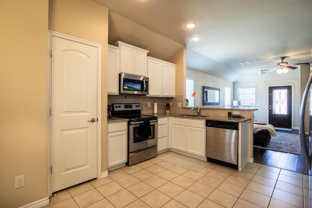 kitchen with white cabinetry, sink, kitchen peninsula, and appliances with stainless steel finishes