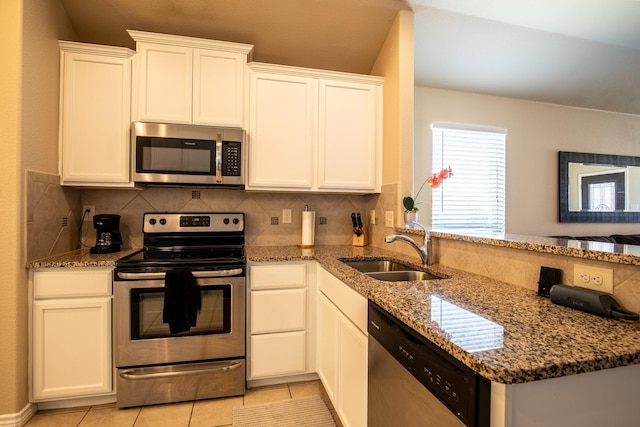 kitchen featuring stainless steel appliances, sink, and white cabinets