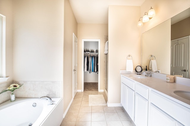 bathroom featuring tile patterned flooring, vanity, and separate shower and tub