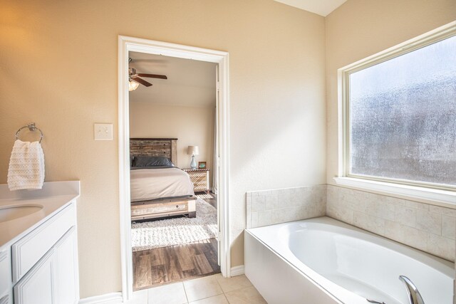 bathroom with vanity, a tub to relax in, tile patterned floors, and ceiling fan