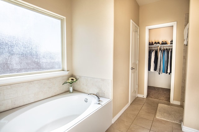 bathroom with tile patterned floors and a washtub