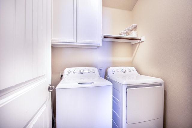 washroom with cabinets and separate washer and dryer