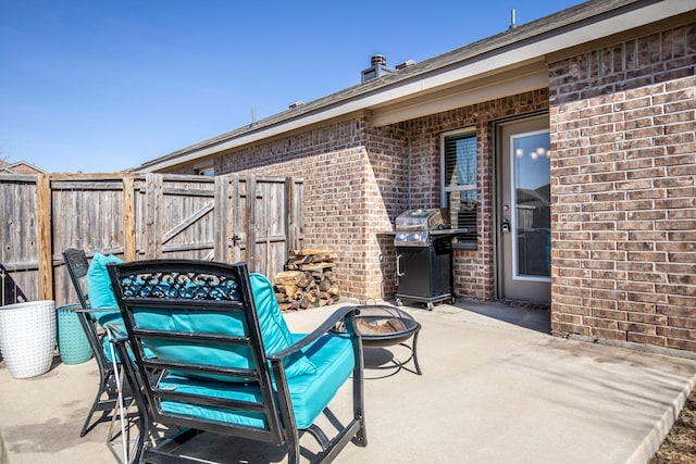 view of patio featuring area for grilling and a fire pit