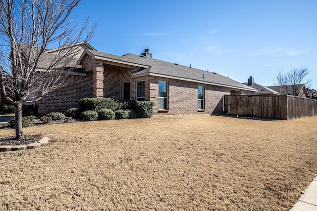 rear view of property featuring a lawn