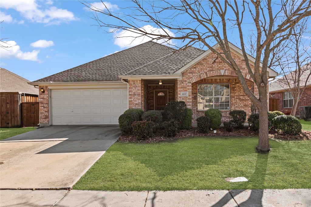 view of front of house featuring a garage and a front lawn