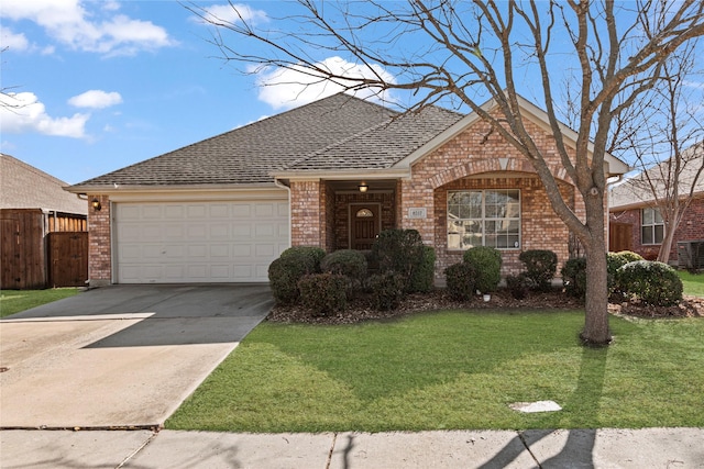 view of front of house featuring a garage and a front lawn