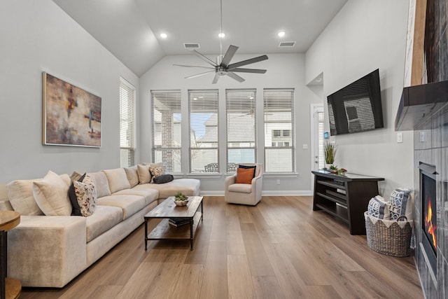 living room with ceiling fan, high vaulted ceiling, and light hardwood / wood-style floors