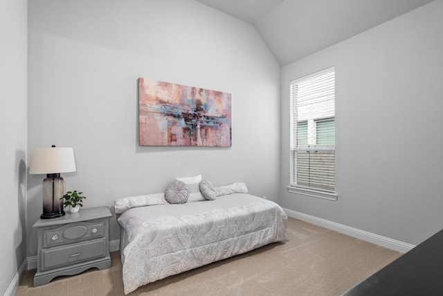 carpeted bedroom with lofted ceiling