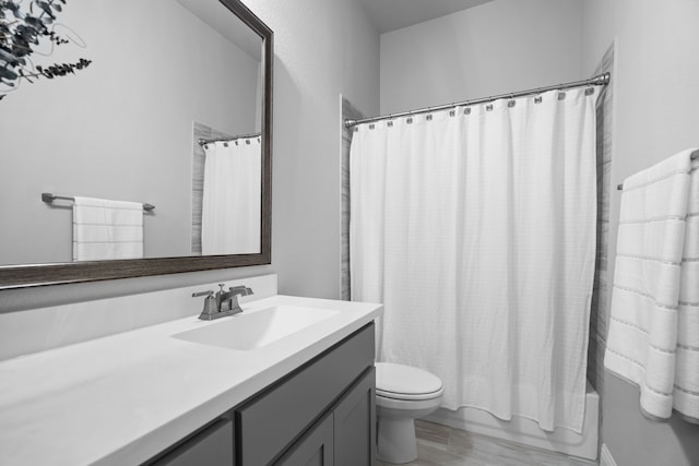 full bathroom with shower / bath combination with curtain, vanity, and toilet