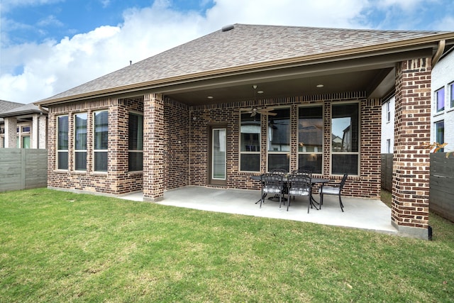 rear view of property with a patio and a yard