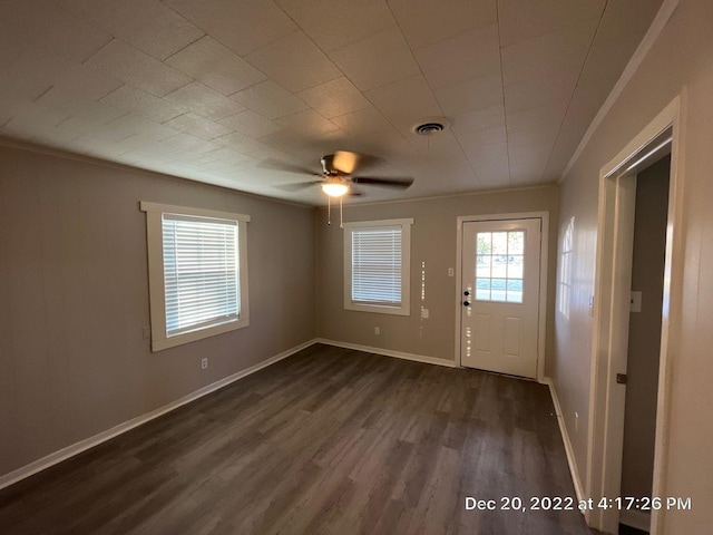 interior space featuring crown molding, dark wood-type flooring, and ceiling fan