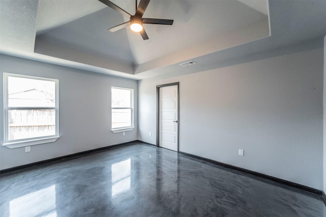 spare room featuring a raised ceiling, lofted ceiling, and ceiling fan