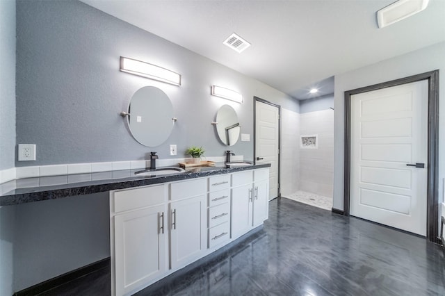 bathroom featuring vanity and a tile shower