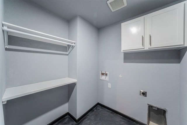 clothes washing area with electric dryer hookup, hookup for a gas dryer, hookup for a washing machine, and cabinets