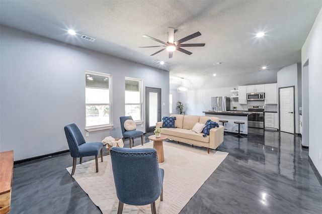 living room featuring a textured ceiling and ceiling fan