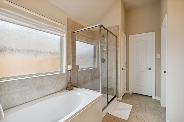 bathroom with tile patterned flooring and independent shower and bath