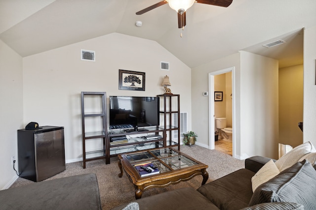 living room featuring lofted ceiling, ceiling fan, and carpet flooring