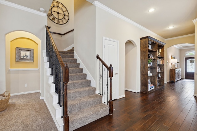 entrance foyer featuring ornamental molding and dark hardwood / wood-style floors