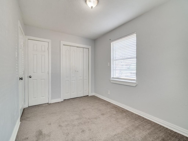 unfurnished bedroom featuring light carpet