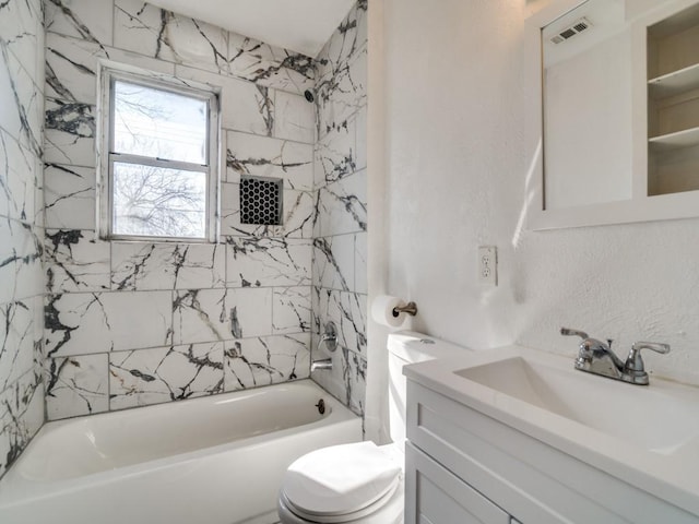 full bathroom with vanity, toilet, and tiled shower / bath combo