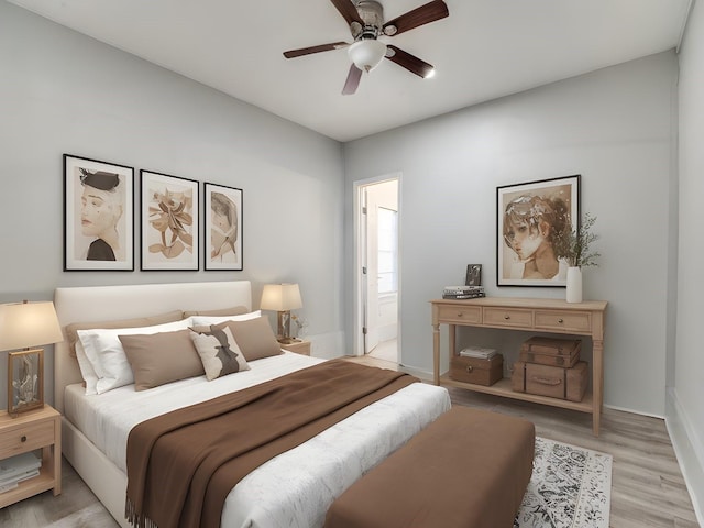 bedroom featuring ceiling fan, ensuite bath, and light hardwood / wood-style flooring