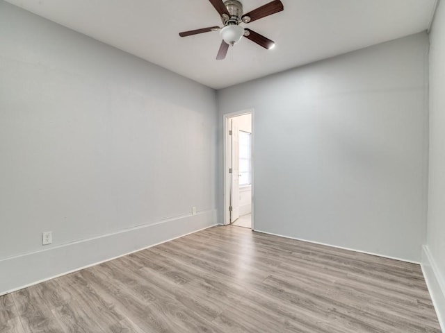 spare room featuring ceiling fan and light hardwood / wood-style flooring