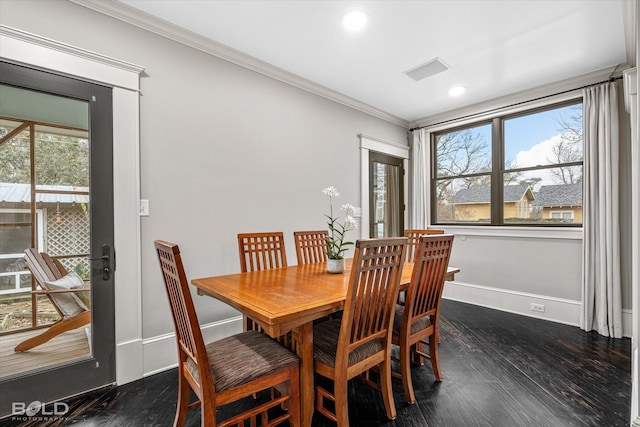 dining area with dark wood-type flooring and ornamental molding