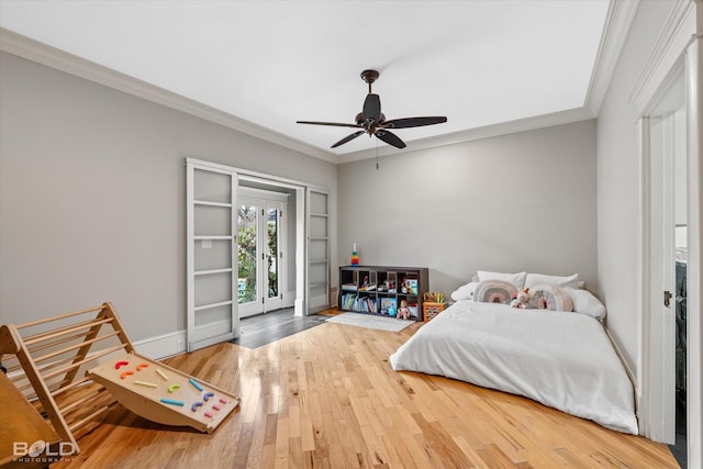 bedroom with crown molding, ceiling fan, wood-type flooring, and access to exterior