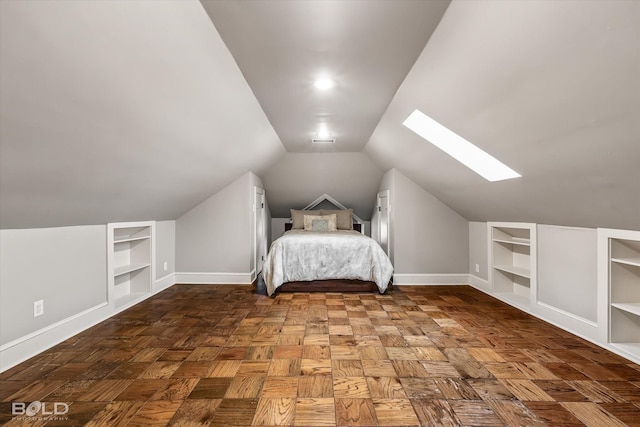 unfurnished bedroom with parquet flooring and vaulted ceiling with skylight